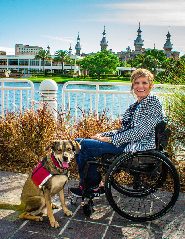 Headshot of Pamela A. Walton & her dog Vinnie infront of the University of Tampa