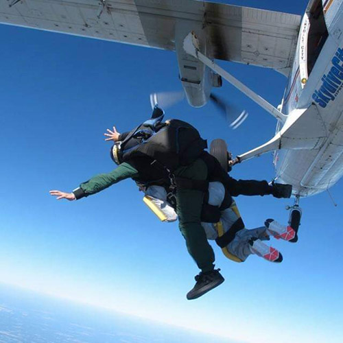 Pamela A. Walton jumping out of an airplane while skydiving